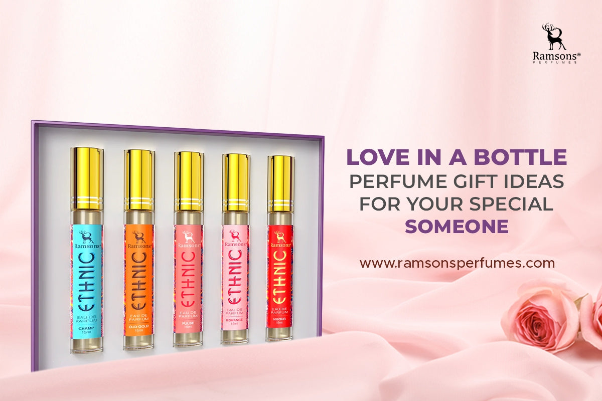 Gift set of five Ramsons Ethnic perfumes with gold caps in a purple box, placed on soft pink fabric with roses in the background.